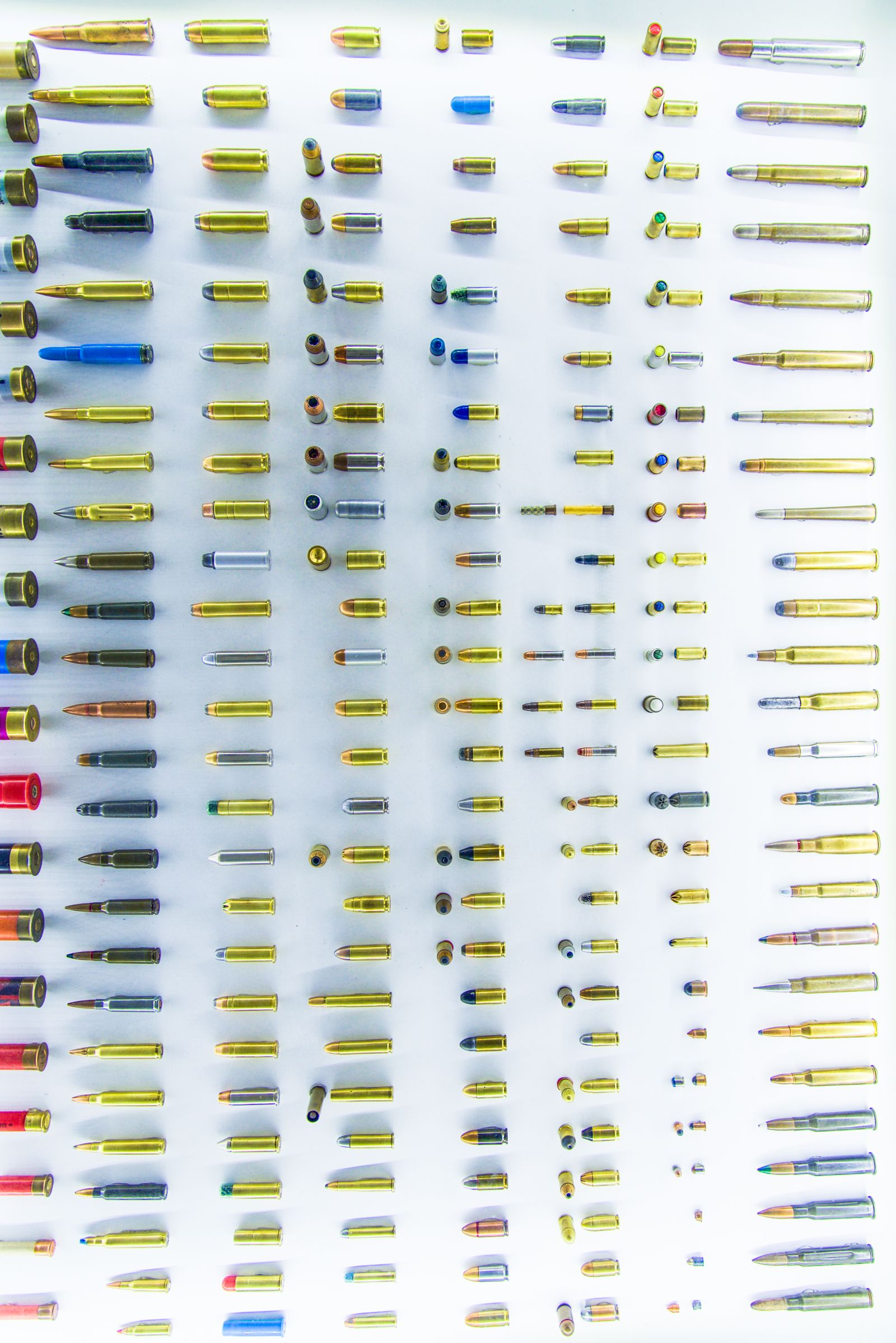Scattered rifle cartridges on a dark surface